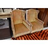 A pair of heavy framed wing back chairs, in the Queen Anne style, later ochre dralon upholstery