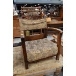 A vintage oak frame low seat armchair