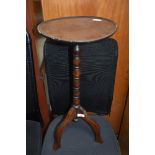 A traditional oak pedestal wine table, diameter approx 30cm, some repair and warping