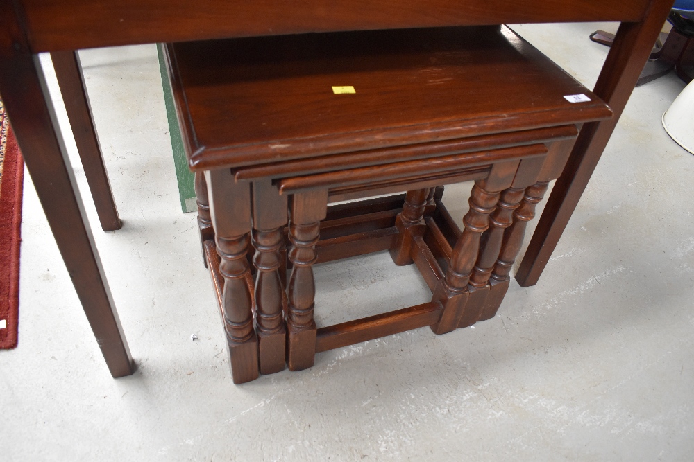 A traditional oak nest of three tables, largest table width approx. 56cm