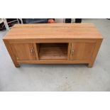 A modern golden oak effect TV unit