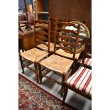 A set of four traditional oak rush seated ladder back chairs