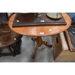 A Victorian satinwood occasional table having oval top on turned column and triple splay base, width