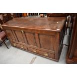A period oak coffer/kist having four panels over double drawer base, dimensions approx. W150 D55