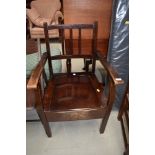A traditional stained frame commode chair
