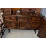 A small long board cupboard in stained oak having three drawers