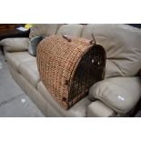 A traditional dome style wicker pet basket, large size, length approx. 60cm, leather strap broken