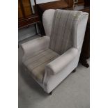 A modern wing backed arm chair