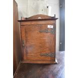 A small oak cupboard possibly a smokers cabinet
