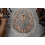 A vintage oval rug, by St Michael, Green Mandarin pattern, approx 152 x 91cm