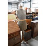 A vintage dressmakers dummy , female form,on wooden tripod base