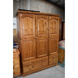 A modern pine triple wardrobe, Kenilworth farmhouse design, having drawer base, width approx. 140cm