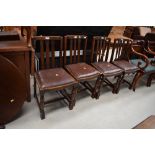 A set of four mid 20th Century oak rail back dining chairs