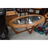 A vintage teak EFFECT laminate and glass oval top coffee table