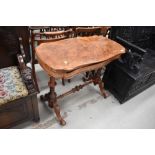 A 19th Century walnut fold over tea table having turned and carved frame, veneers lifting quite