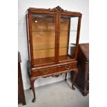 A modern continental style display cabinet on cabriole legs