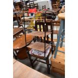 A mid 20th century rail back dining chair and a modern storage rack