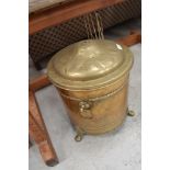 A brass coal bin with metal liner