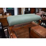 An early 20th Century footstool on Queen Anne style legs with later green upholstery, width approx