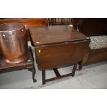 A dark stained Ercol style drawer leaf dining table, approx. width 47cm