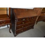 An antique writing bureau and three over two drawer set with compartmental interior and drop front