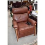 A modern leather and wood frame electric recliner chair