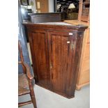 A Georgian oak corner cupboard having interesting shelved interior, width approx. 85cm