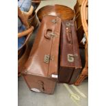 Two vintage leather bound travel trunks or suitcases