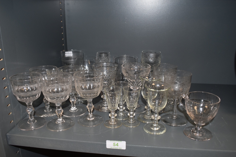 A selection of vintage glasses including Victorian sherry glasses and etched wine glasses.