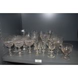 A selection of vintage glasses including Victorian sherry glasses and etched wine glasses.