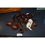An array of vintage traditional pipes, names such as Carey Magic inch,Bari Ruby etc, some clay bowls