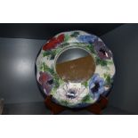 A Highland stoneware mirror having decorative abstract Anemone pattern to frame.