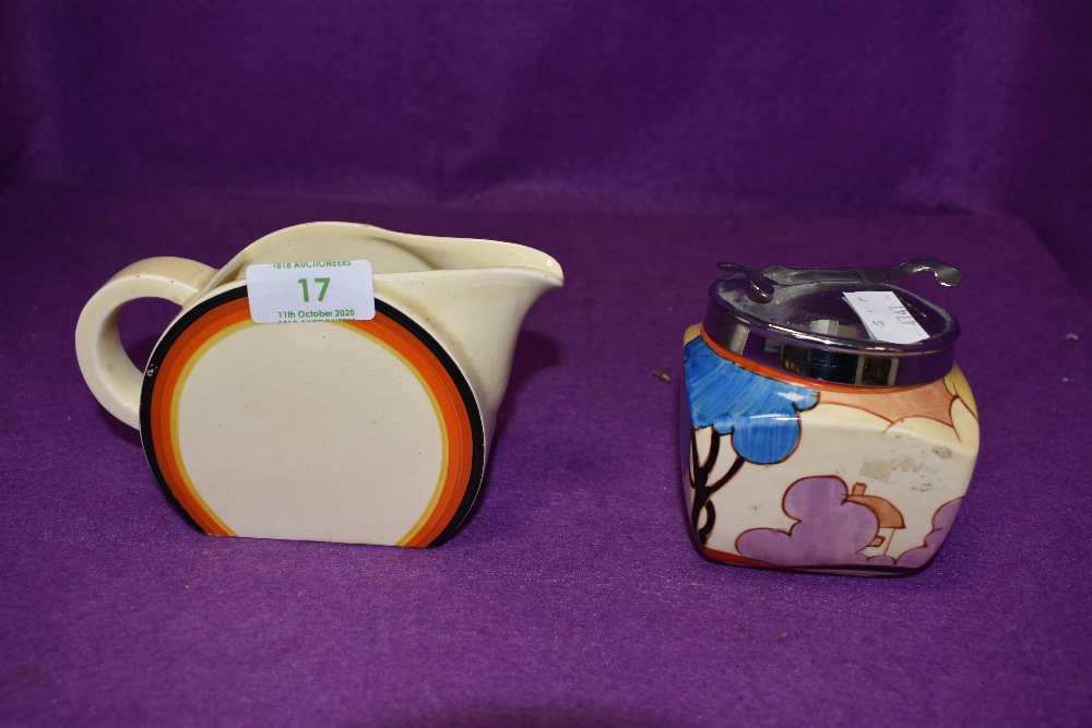 Two 'Bizzare' by Clarice Cliff items, a jug measuring approx 9.5cm in height, and a sugar bowl