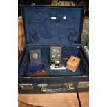 A selection of curios and collectables in suitcase including bakelite frame Post office savings bank