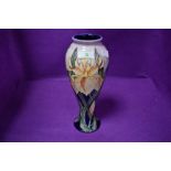 A Moorcroft baluster vase,having tube lined iris design in yellow on pink and blue ground designed