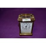 A brass cased French carriage clock having enamel face plate