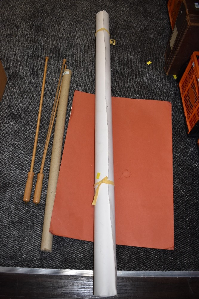 A large roll of photography studio paper and handles??