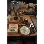 An assortment of items including a set of wooden owls, a wall clock, pipe and similar.