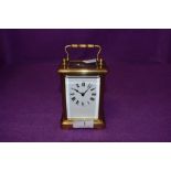 A French carriage clock having bevelled glass panels to all sides and Roman numerals to face.