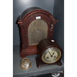An early plastic Enfield chiming mantel clock and similar wooden cased mantel clock with bevelled