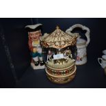 A large musical snow/glitter dome having carousel scene, a floral tea pot and a Burlington ware