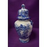 A large vintage blue and white lidded jar or urn, some colour restoration in places.