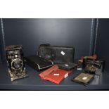 A selection of vintage cameras, including Vest pocket Kodak,Rollex vuiglander plate camera and