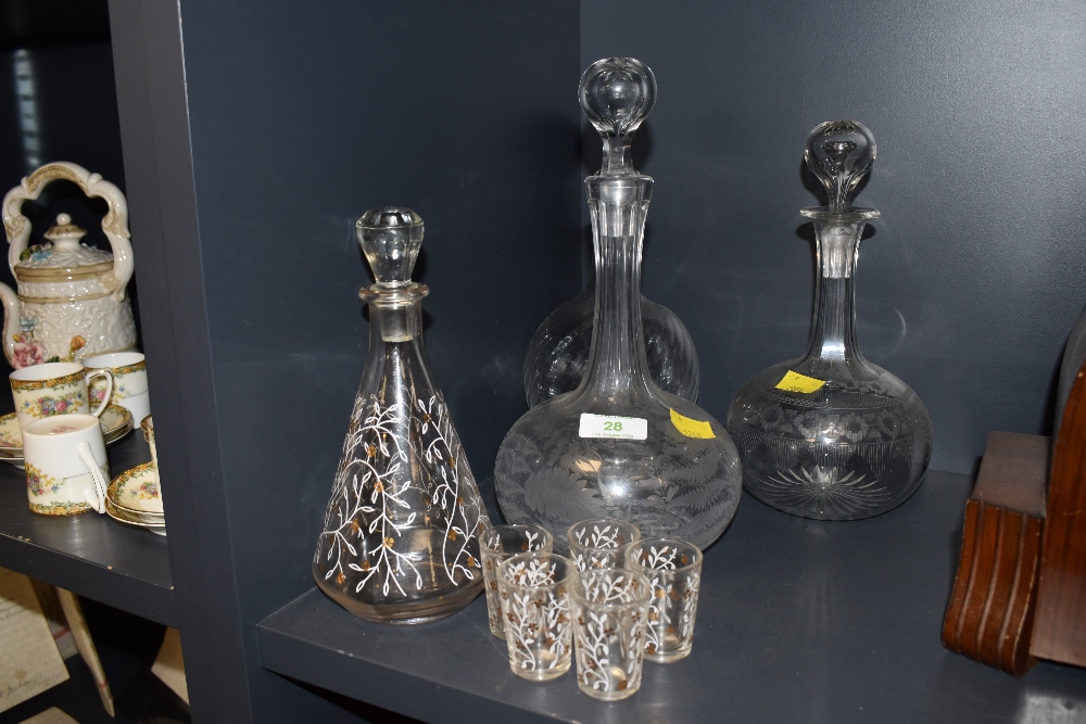 A lot of three late 19th early 20th century decanters some of which are etched and similar gilt