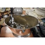 A large ice bucket having decorative handles and a vintage bar mounted cork screw with wooden