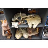 Two shelves of vintage Star Wars vehicles and accessories including two Millennium Falcons, Rebel
