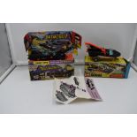 Two Corgi diecasts, Bat Mobile, with Batman and Robin figures present, on card display stand with