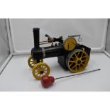 A Mamod Live Steam Traction Engine, having yellow wheels, missing canopy