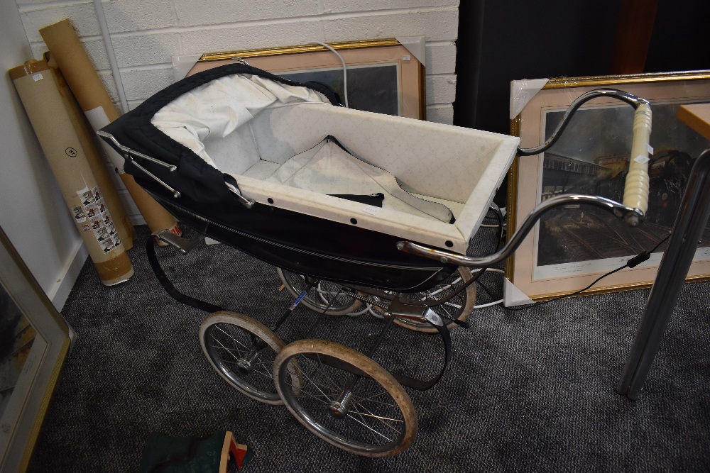 A 1960's Silver Cross Dolls Pram having dark blue hood and canopy on sprung chassis with twin