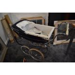 A 1960's Silver Cross Dolls Pram having dark blue hood and canopy on sprung chassis with twin